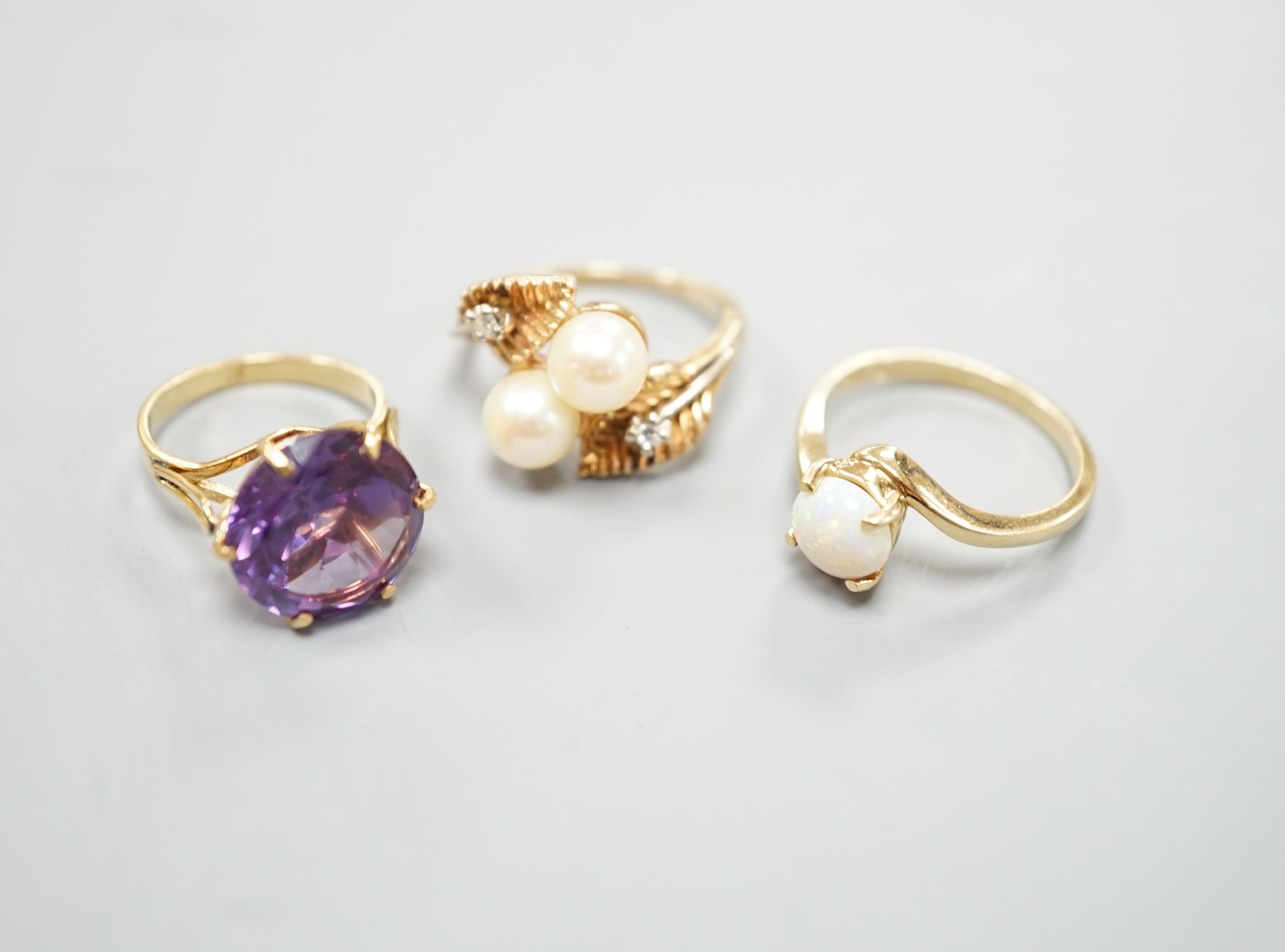 Three assorted modern 14k and gem set dress rings, including white opal, size L, gross 10.3 grams